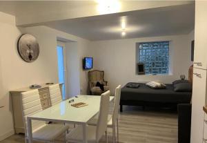 a room with a bed and a table and a bedroom at Hôtel&Restaurant HDLV climatisées in Ornans