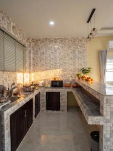 a kitchen with a large counter top in a room at The Triangle Villas in Srithanu +4 photos