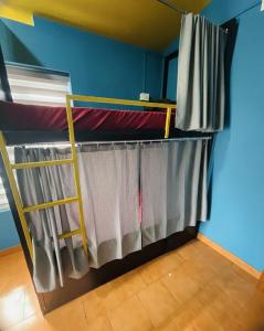 a room with two bunk beds in a room at Avenue Dorms in Kalpetta