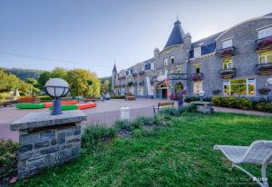 a building with a yard with chairs and a street at Floreal La Roche-en-Ardenne in La-Roche-en-Ardenne