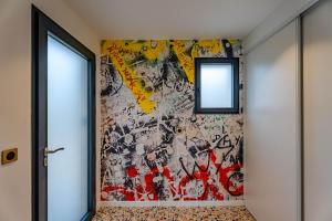 a hallway with a wall covered in graffiti at Coquelicot in Caen