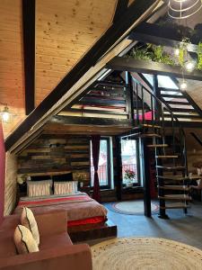 a bedroom with a bed and a staircase in a room at Hanul Anei - entire property in Braşov