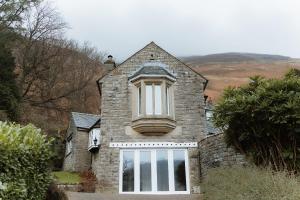 a house with a window on top of it at Grey Walls in Penrith