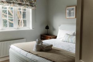 a bedroom with a bed with a stuffed animal on it at Grey Walls in Penrith