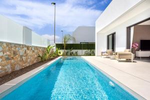 a swimming pool in the backyard of a house at Villa Palmera in San Javier