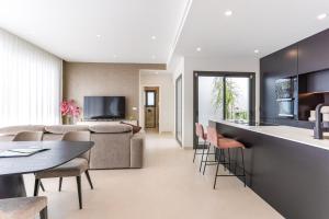 a living room with a couch and a table and chairs at Villa Palmera in San Javier
