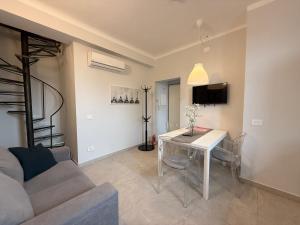 a living room with a table and a couch at Monza Downtown House Via Bartolomeo Zucchi 5 Monza in Monza