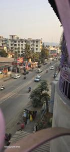 a view of a city street with cars on the road at Lavish Abode black & white in Guwahati