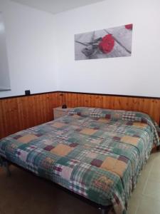 a bedroom with a bed with a quilt on it at CT ROOMs in Invorio Inferiore