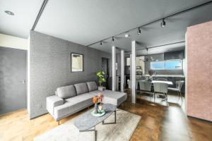 a living room with a couch and a dining room at Prunoia in Furano