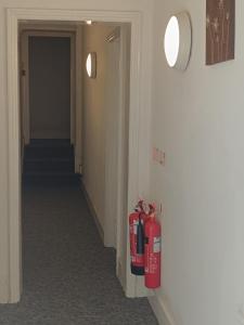 a hallway with two fire hydrants on the wall at Bristol Hotel in Bristol