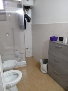 a bathroom with a toilet and a shower and a sink at CT ROOMs in Invorio Inferiore