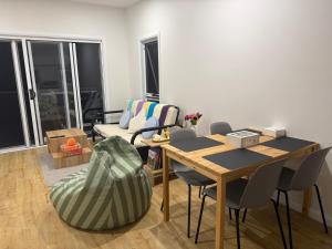 a living room with a table and chairs and a couch at Cosy Granny flat in Epping in Epping