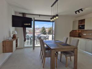 a kitchen and dining room with a wooden table and chairs at Natalija City 2 in Krk