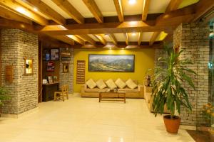 a living room with a couch and a table at Bodhi Suite Boutique Hotel & Wellness in Pokhara