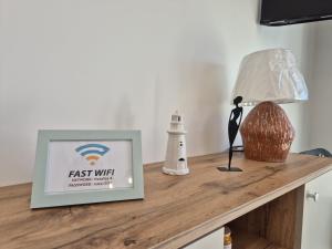 a table with a lamp and a picture on it at Natalija City 2 in Krk