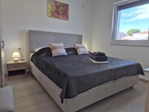 a large bed in a bedroom with a window at Natalija City 2 in Krk +27 photos