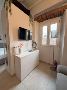 a living room with a tv on the wall at Monza Downtown House Via Bartolomeo Zucchi 5 Monza in Monza +10 photos