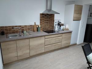 a kitchen with a sink and a stove at Cozyhouse in Touquet Berthe +4 photos