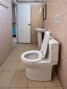 a bathroom with a toilet and a sink at Baan Mak Mai Hotel in Si Sa Ket +34 photos