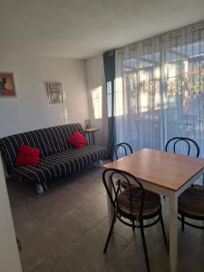 a living room with a couch and a table with chairs at Flassans Gites &Spa in Flassans-sur-Issole