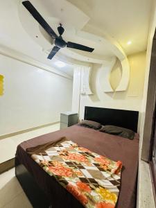 a bedroom with a bed and a ceiling fan at DIAMOND PALACE Kalasipalya in Bangalore