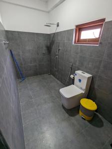 a bathroom with a toilet and a shower at Mango Tree Weligama in Weligama