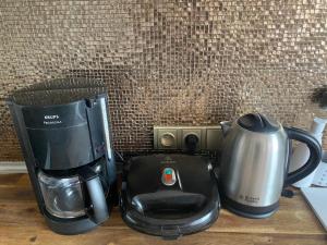 a coffee maker and a tea kettle on a counter at ARTep apartment in Pilsen