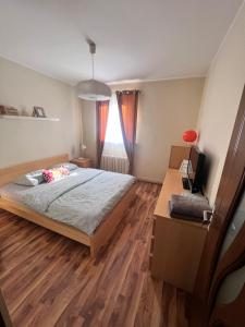 a bedroom with a bed and a wooden floor at Middeltown rose in Alba Iulia