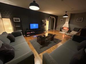 a living room with a couch and a tv at Lovely house in Abisko in Abisko