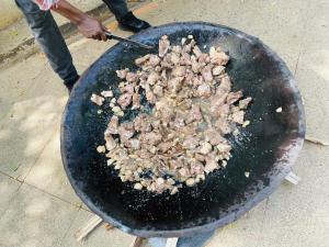 a person is cooking food on a grill at Bete Selam in Bahir Dar