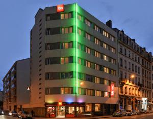 a building with a green light on the side of it at ibis Lyon Centre in Lyon