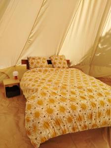 a bedroom with a bed in a tent at Chez Tombivouac in Pierrefonds