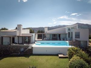 a house with a swimming pool in the yard at Villa Dei Sogni, for the Design Lovers,By ThinkVilla in Agia Pelagia