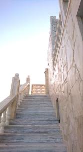 a stairway leading up to a building with a stone wall at Castellino Studios in Faliraki