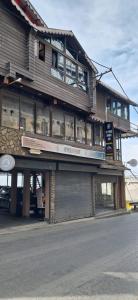 a large wooden building with a store at Beyond Baari Inn in Darjeeling