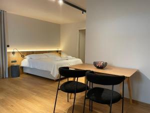 a bedroom with a bed and a table and chairs at Philoxenia by nature in Karkaloú