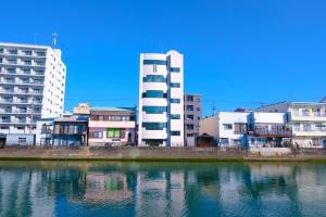 a group of buildings next to a body of water at ゲストハウス 清水銀座 in Shizuoka
