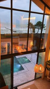 a room with a view of a swimming pool and the ocean at Villa Bella in Atakum