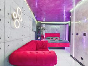 a red couch in a room with a bed at LoveAparts Marki Romantic Stay in Marki +38 photos