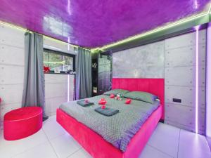 a bedroom with a red bed and a purple ceiling at LoveAparts Marki Romantic Stay in Marki