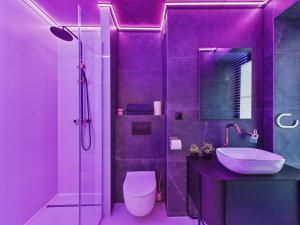 a purple bathroom with a toilet and a sink at LoveAparts Marki Romantic Stay in Marki