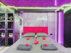 a bedroom with a large bed with red roses on it at LoveAparts Marki Romantic Stay in Marki