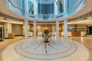 a large lobby with a fountain in the middle of a building at Limak Atlantis Deluxe Hotel Belek in Belek +175 photos