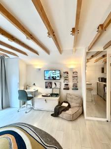 a room with a bed and a desk and a tv at Modern self contained tiny home with patio in Loughton +3 photos