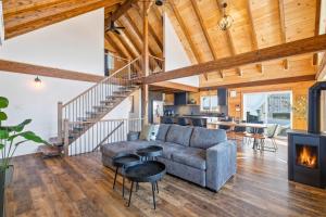 a living room with a couch and a fireplace at Spa Pool Table Ultimate Comfort - OSE Le Refuge in Saint Come