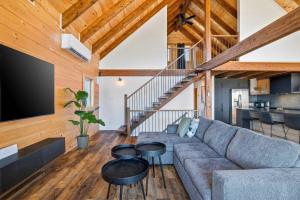 a living room with a couch and a tv at Spa Pool Table Ultimate Comfort - OSE Le Refuge in Saint Come +58 photos