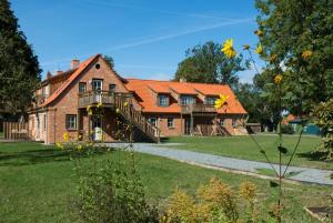 a house with an orange roof and a yard at Clara Elisabeth in Döhnsdorf