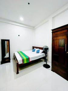 a bedroom with a bed and a lamp in it at Lotus villa in Matara