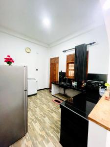 a kitchen with a stainless steel refrigerator in a room at Lotus villa in Matara